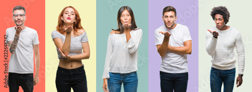 Composition of african american, hispanic and chinese group of people over vintage color background looking at the camera blowing a kiss with hand on air being lovely and sexy. Love expression. © Krakenimages.com