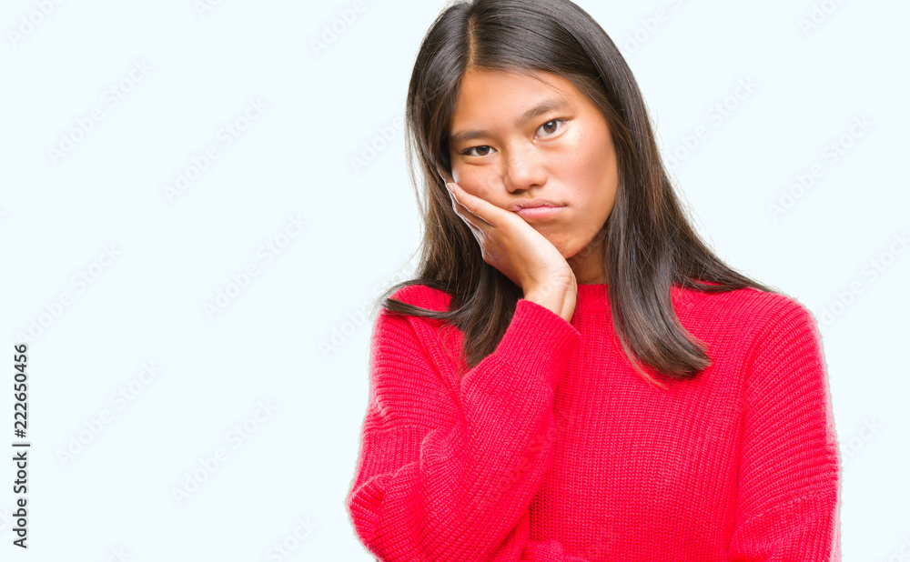 Young asian woman wearing winter sweater over isolated background thinking looking tired and bored with depression problems with crossed arms. Young asian woman wearing winter sweater over isolated background thinking looking tired and bored with depression problems with crossed arms.