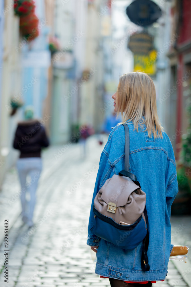Young lady in jeans jacket on medieval street of Bremen, Germany. Trevel destination concept