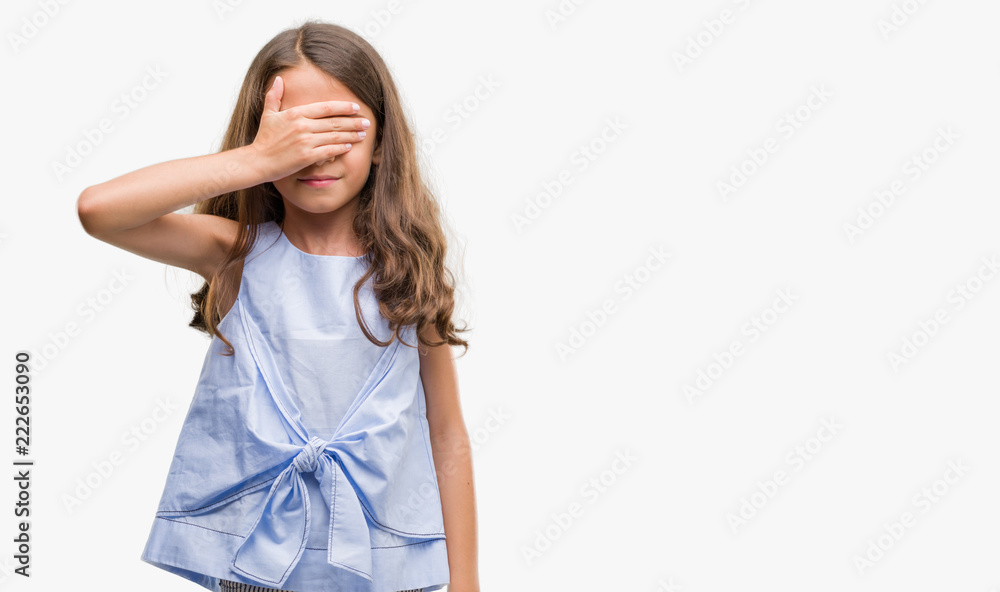 Brunette hispanic girl smiling and laughing with hand on face covering eyes for surprise. Blind concept. Brunette hispanic girl smiling and laughing with hand on face covering eyes for surprise. Blind concept.