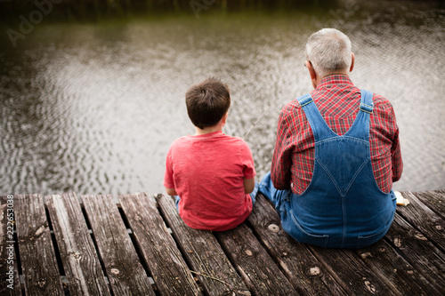Happy Great Grandfather and Grandson Fishing Together