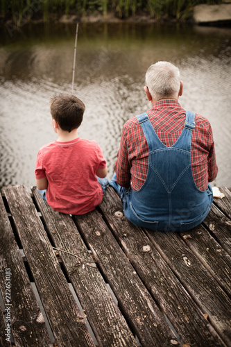 Happy Great Grandfather and Grandson Fishing Together