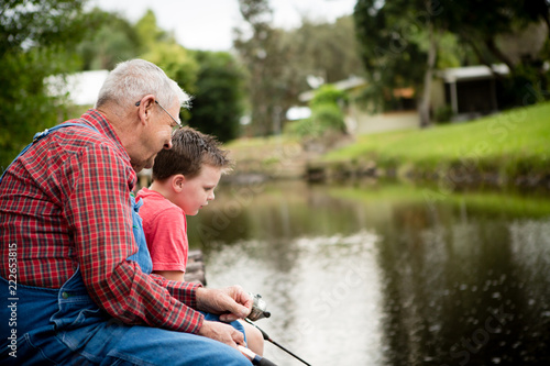 Happy Great Grandfather and Grandson Fishing Together