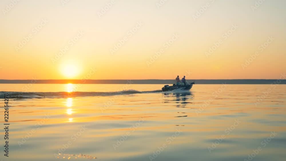 Sunrise landscape with a speedboat floating across the lake Sunrise landscape with a speedboat floating across the lake