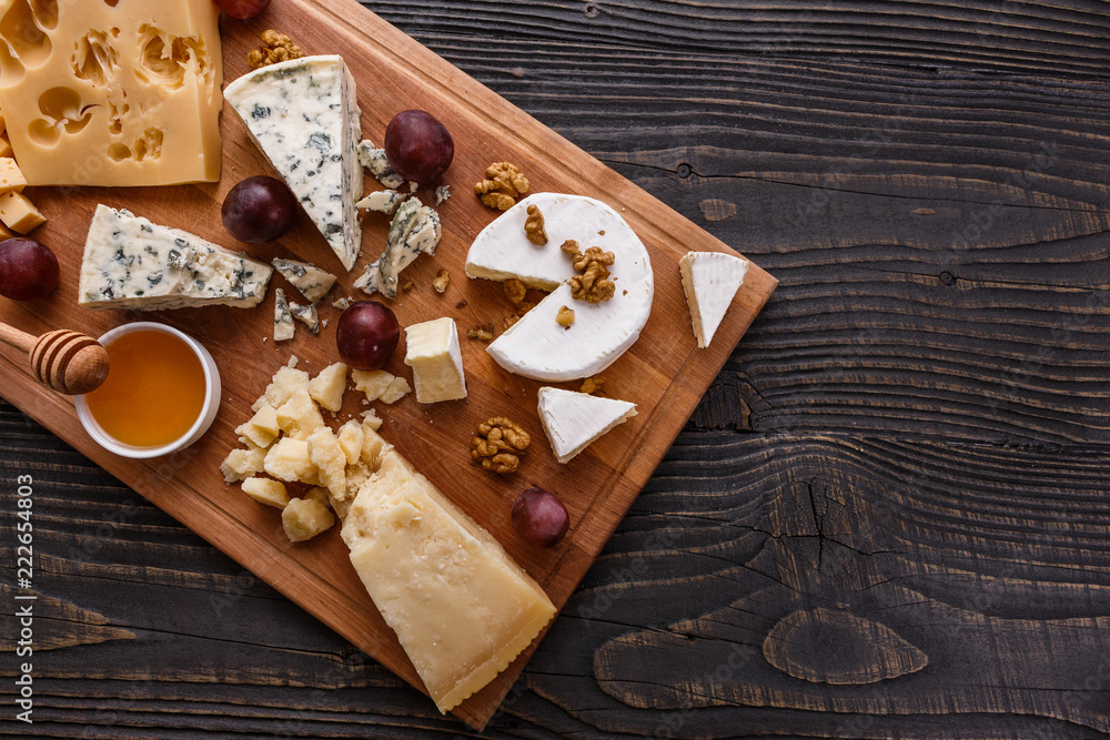 set of different cheeses on a wooden rustic background set of different cheeses on a wooden rustic background