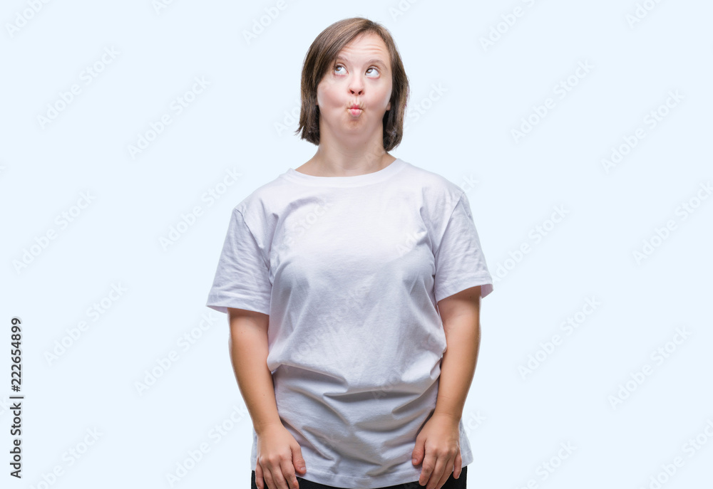 Young adult woman with down syndrome over isolated background making fish face with lips, crazy and comical gesture. Funny expression. Young adult woman with down syndrome over isolated background making fish face with lips, crazy and comical gesture. Funny expression.