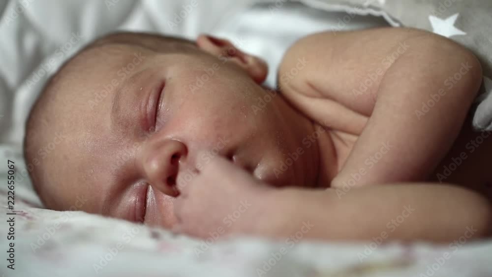 Newborn 2 weeks old baby boy lies on the bed and sleeps Newborn 2 weeks old baby boy lies on the bed and sleeps