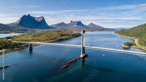 Aerial shot of a suspension bridge over Efjord with mountain Stortinden in the background, Ballangen, Norway