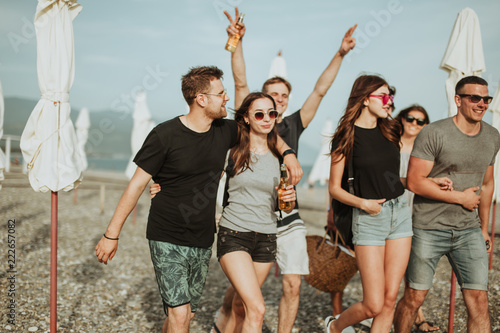 People Group of best friends or students On Beach. Summer Vacation, Happy Smiling people Walking along Sea Ocean. travel, holiday concept