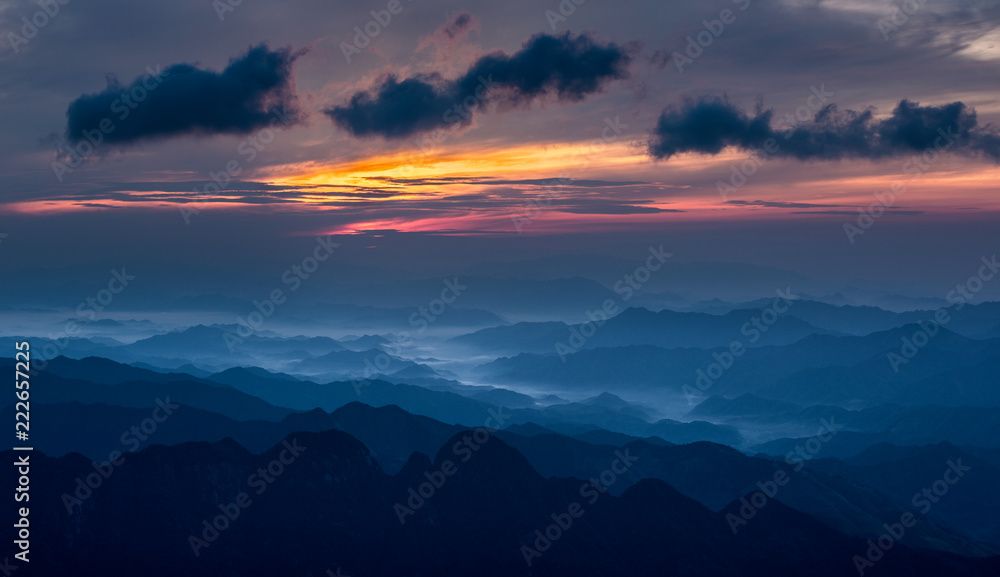 Sanqingshan Mountain Sunrise, Mount Sanqing National Park - Jiangxi Province China. National Geopark and Sacred Taoist Mountain, UNESCO World Heritage. Clouds, Valley, Blue Mist, Orange and Purple Sky