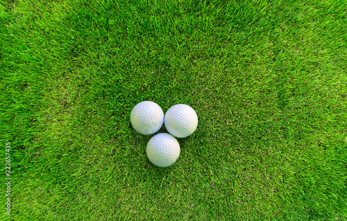 Three Golf Balls Lying on Green Grass View from Above