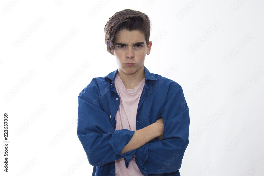 young teenager or child with an expression of anger isolated in white young teenager or child with an expression of anger isolated in white
