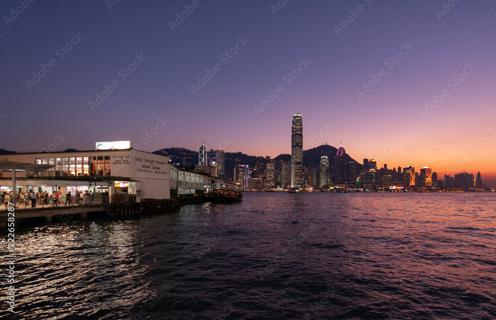 Hong Kong City Skyline with Evening Sun and orange Sky on Sunset
