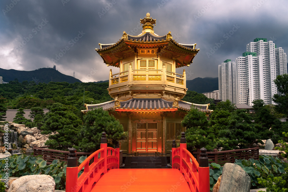 Fototapeta premium Golden Temple in Hong Kong Nan Lian Garden with Stormy clouds