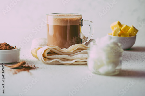 BULLETPROOF CACAO. Ketogenic keto diet hot drink. Cacao blended with coconut oil and butter. Cup of bulletproof cacao and ingredients on white background photo