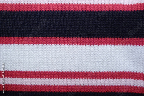 knitted woolen fabric close-up natural material geometric pattern stripes red white black