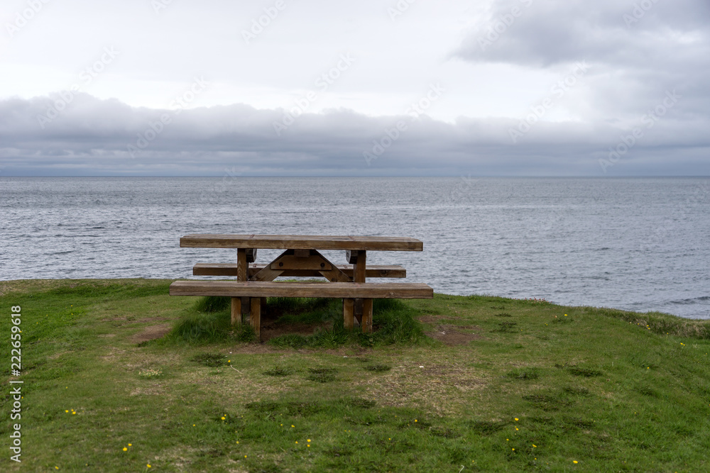 Empty wooden bench with view over fjord in Iceland