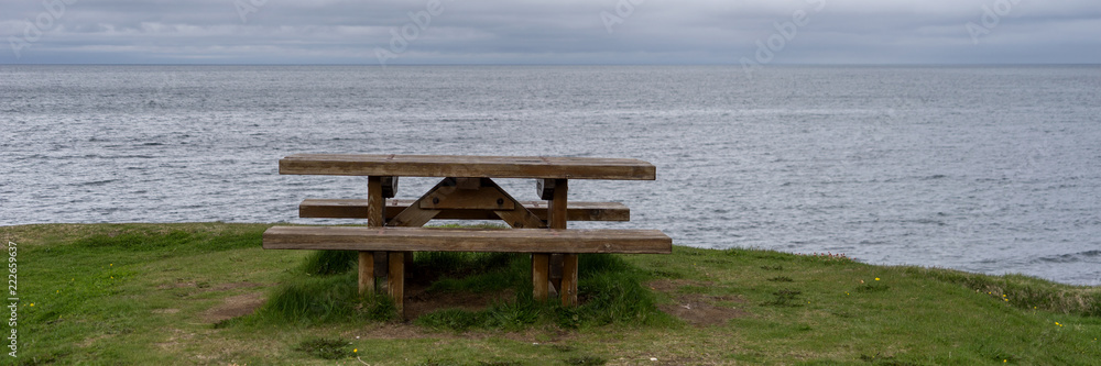 Empty wooden bench with view over fjord in Iceland