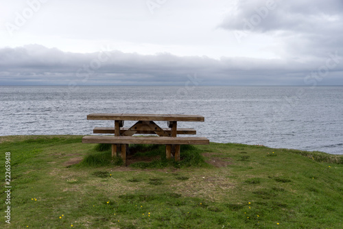 Empty wooden bench with view over fjord in Iceland