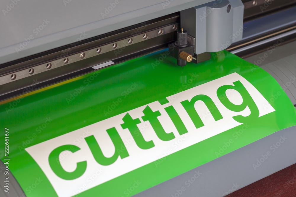 Cutting plotter close-up. The process of cutting a vinyl film. Cutting plotter close-up. The process of cutting a vinyl film.