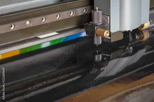 Cutting plotter close-up. The process of cutting a vinyl film.