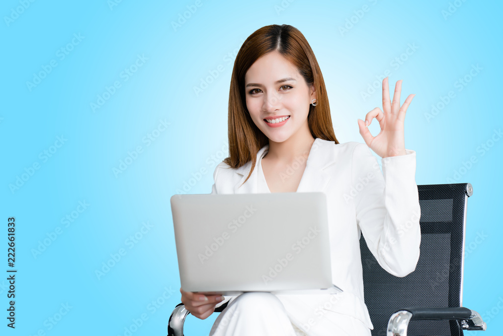 Portrait, Asian business woman raised her hand show okay. Because it has agreed to contract with the customer through laptop. This is where learning to find information is good. isolated clipping path Portrait, Asian business woman raised her hand show okay. Because it has agreed to contract with the customer through laptop. This is where learning to find information is good. isolated clipping path