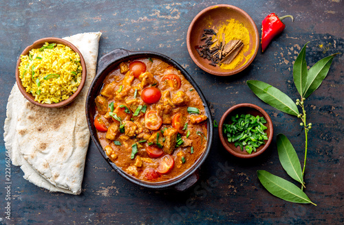 INDIAN FOOD. ROGAN JOSH curry sauce. Pork rogan josh with rice and naan bread photo