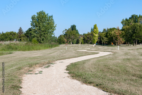 Winding Gravel Path Through Green Prairie Parkland