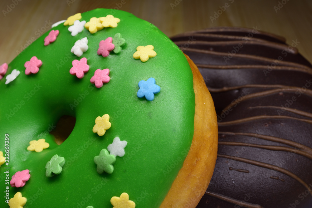 Green and chocolate donuts on the wooden table Green and chocolate donuts on the wooden table
