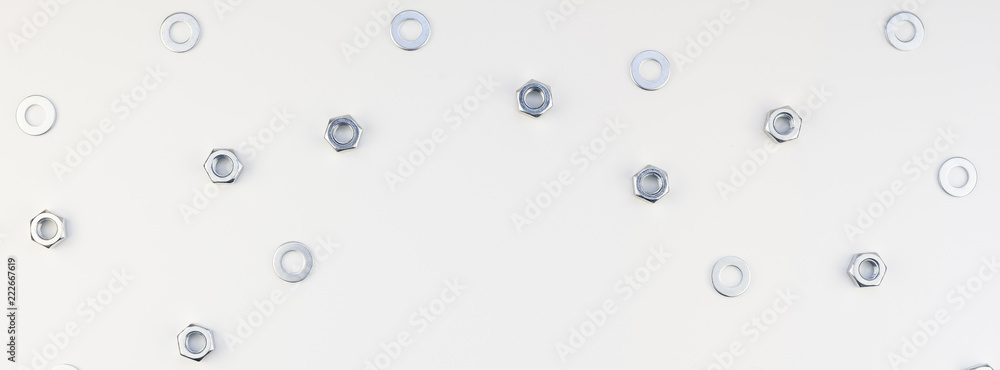 Flat lay of metal nuts on white background