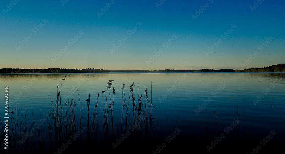 sunset at saimaa lake in finland