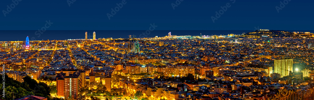 Barcelona skyline at night looking towards the sea showing emblematic buildings such as Agbar tower, Sagrada Familia, W hotel, Arts hotel and Montjuic castle