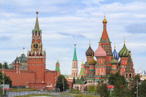 St. Basil's Cathedral on Red square and Moscow Kremlin with Spasskaya tower on a cloudy sky background in summer day