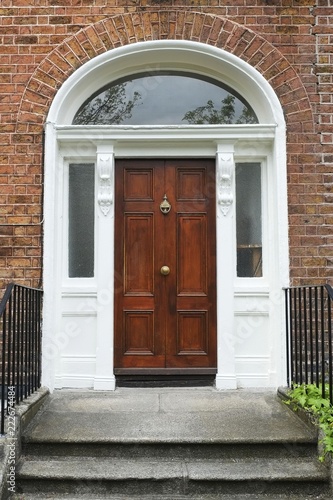 A tipical brown wooden door in Dublin of a victorian house