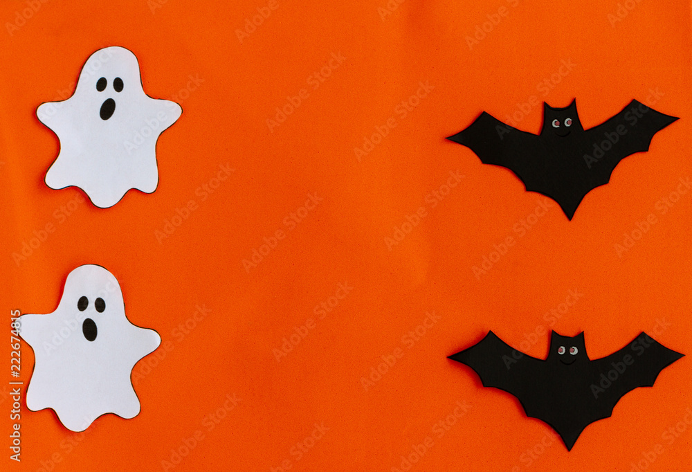 Elements of halloween decoration, bats  and ghots on orange background. Holidays, decoration and party concept. Top View. Copy Space