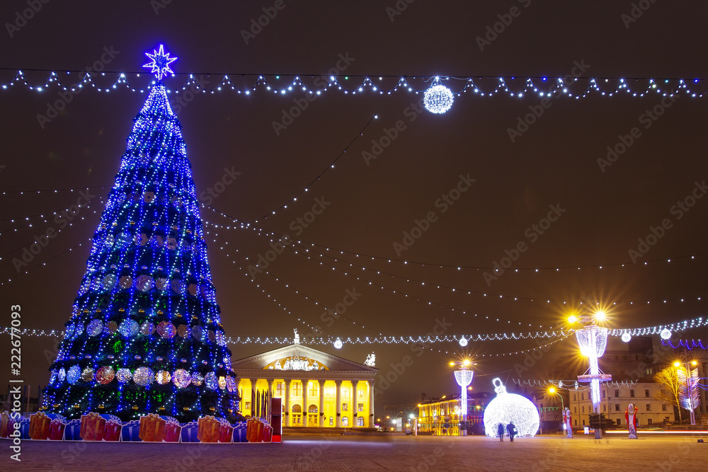 Minsk, Belarus - january 9, 2018: Festive decorated Christmas tree on square in winter Minsk. Celebration New Year and Xmas in night Minsk