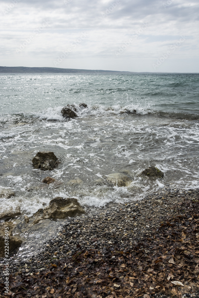 Coastline with stone beach. Waves in the sea water. Landscape sea with rocks. Coastline with stone beach. Waves in the sea water. Landscape sea with rocks.