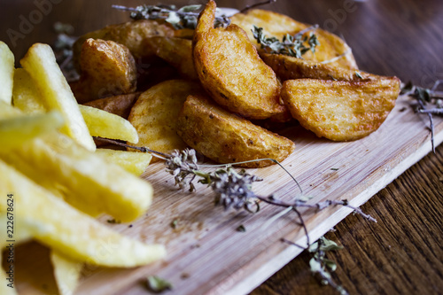 French fries and baked potatoes with dry greenery