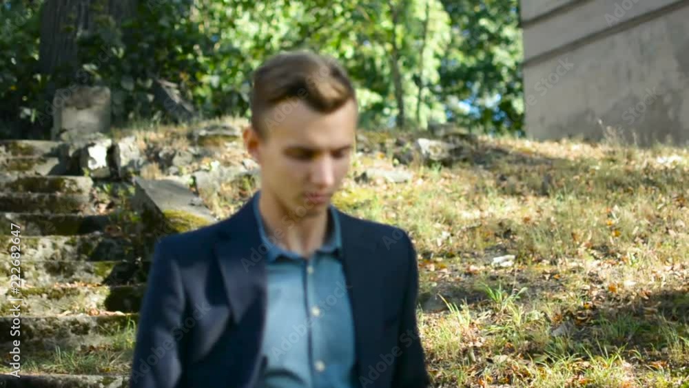 Young businessman architect walking down the stairs after expecting very old abandoned destroyed building Young businessman architect walking down the stairs after expecting very old abandoned destroyed building