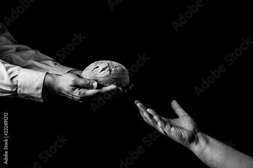 Canvas Print Man giving Bread to person in need