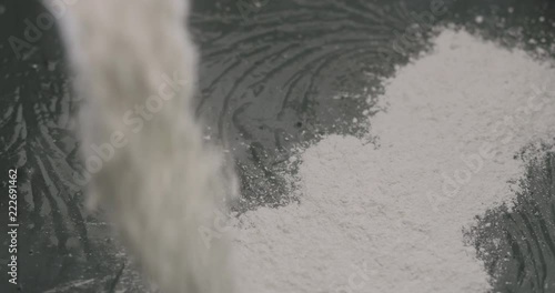Slow motion adding hardener to micro concrete plaster