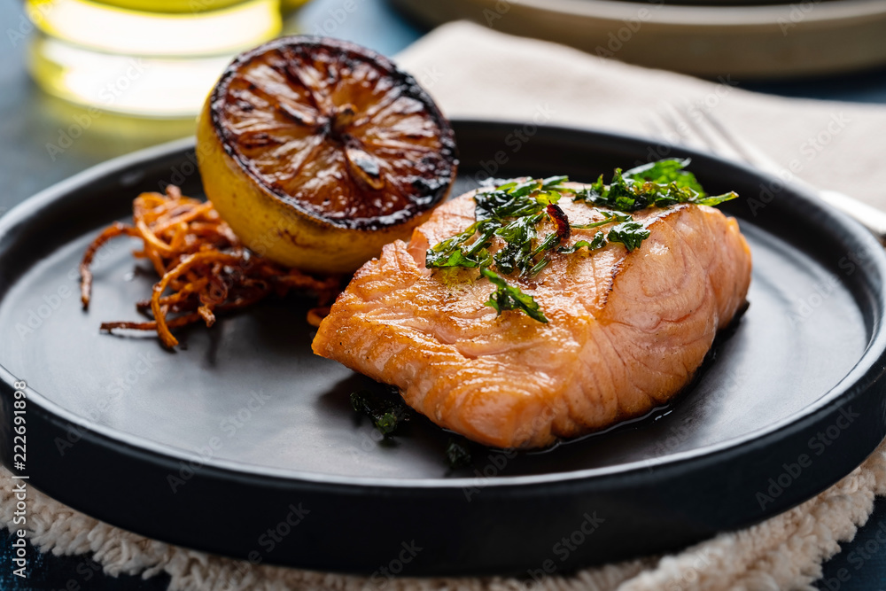 Salmon Sole Meuniere with lemon. Fillet of red fish. Steak trout fried with butter, lemon and parsley sauce Salmon Sole Meuniere with lemon. Fillet of red fish. Steak trout fried with butter, lemon and parsley sauce