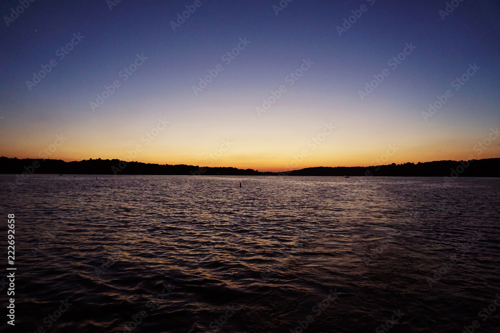 big vast lake water wiht colorful sunset