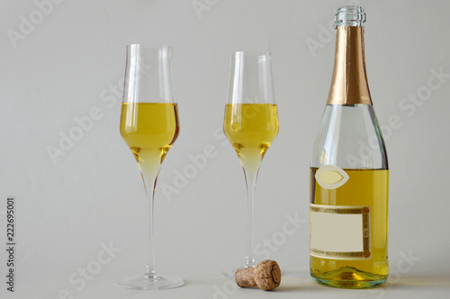 Two glasses of spumante wine on white background
