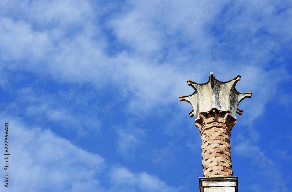 Close-up of the little tower above a Venetian style building. Sky on background. Este, Padova, Italy