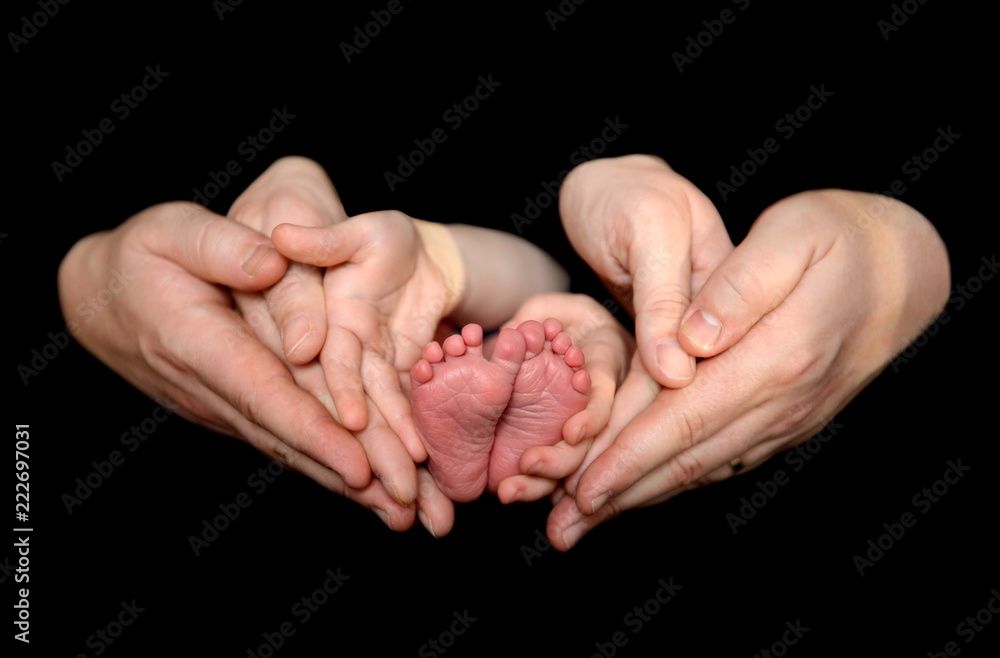 Newborn baby feet on father and mother hands Newborn baby feet on father and mother hands