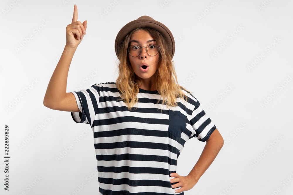 woman in hat and eyeglasses pointing up to copy space over white background woman in hat and eyeglasses pointing up to copy space over white background