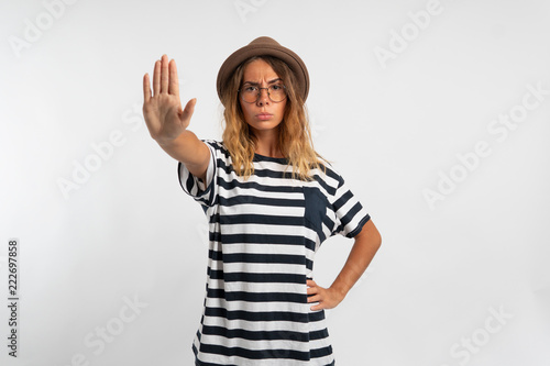 girl with outstretched hand shows the stop over white background © South House Studio