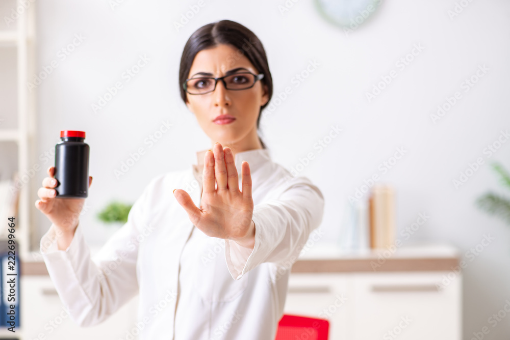Woman doctor with bottle of medicines Woman doctor with bottle of medicines