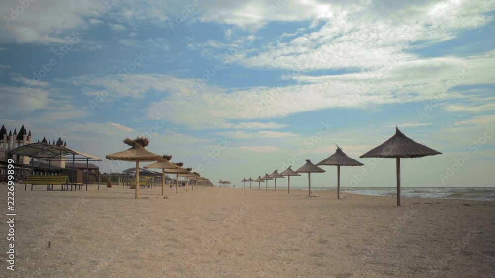 Straw Umbrellas from the Sun Morning on the Sea Beach Straw Umbrellas from the Sun Morning on the Sea Beach